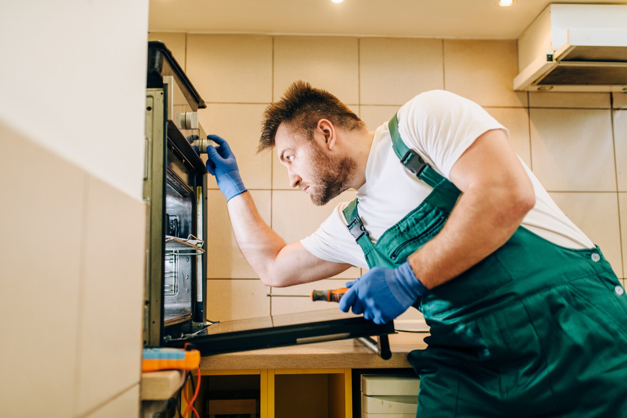 repairman uniform checks oven technician professional worker makes repairs around house home repairi